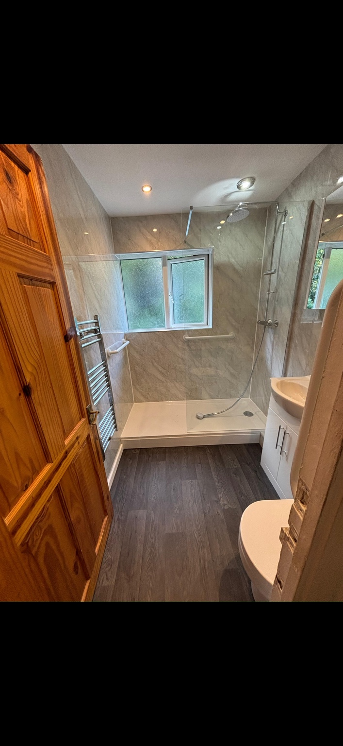 Completed shower room with glass screen and wall panels