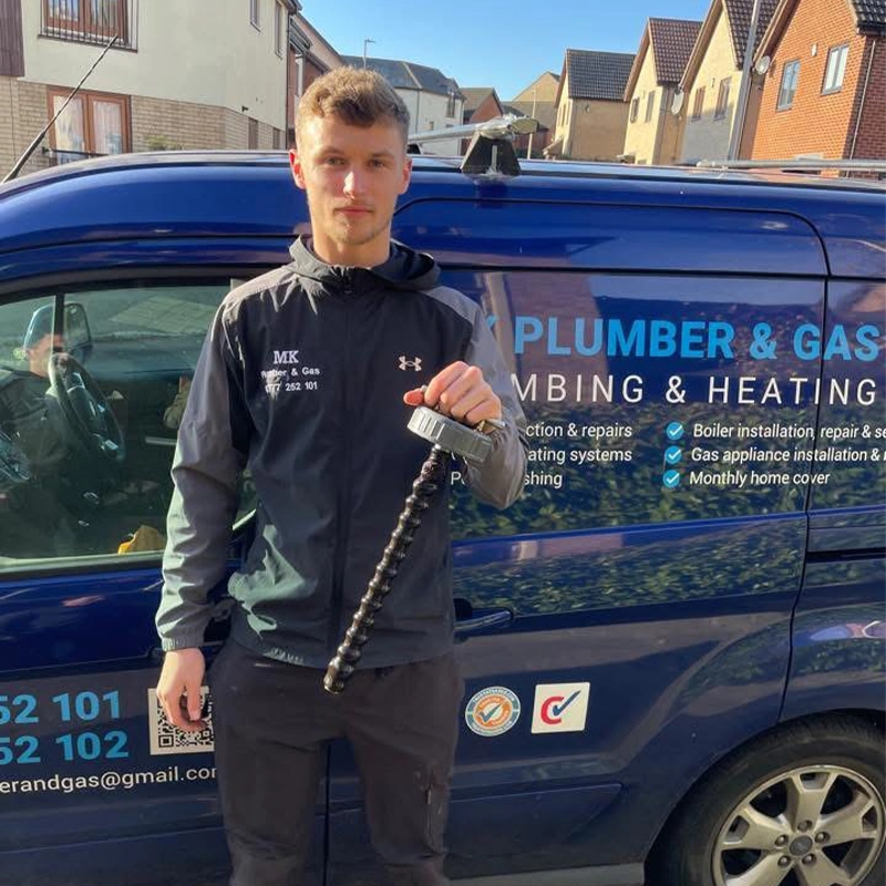 MK Plumber & Gas team member pictured beside the branded company van